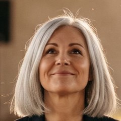 A business owner with silver hair, smiling (Illustration)