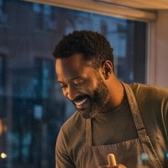 A teammate in an apron smiling at his work (Illustration)